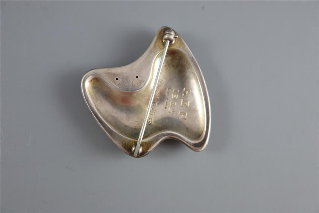A late 1960s Danish Georg Jensen silver and green enamel abstract brooch, designed by Henning Koppel, design no. 315,